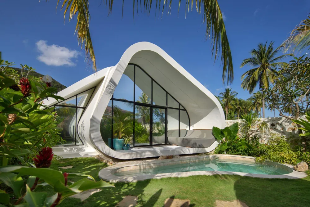 Curved modular home with glazed frontage and a pool